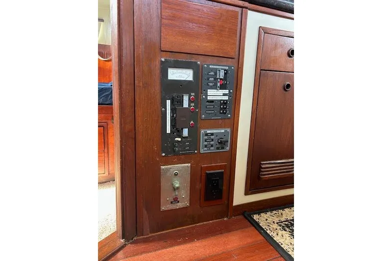 Slide: The Image of Control panel on a 1985 Custom 60 boat, featuring switches and gauges. - 22