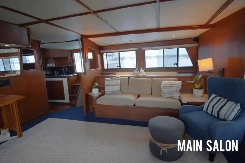 Slide: The Image of Main salon of 1985 Custom 60 yacht with cozy seating and nautical decor. - 44