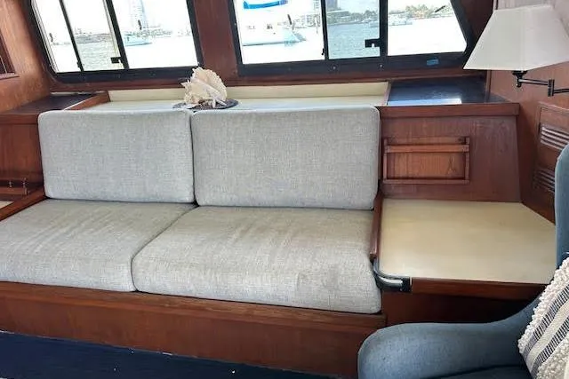 Slide: The Image of Interior of a 1985 Custom 60 yacht with a cozy seating area and large windows. - 50