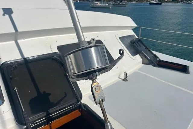 Slide: The Image of Sailboat deck with rigging, Custom 60 model, 1985, ocean view in background. - 60