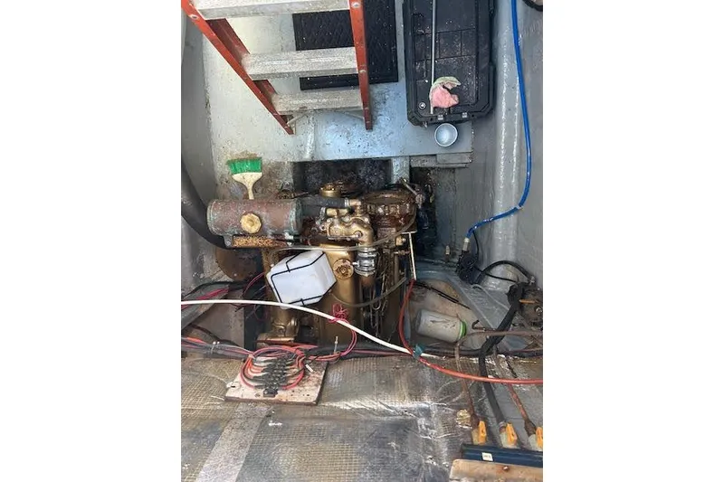 Slide: The Image of Engine room of a 1985 Custom 60 boat with visible wiring and components. - 67