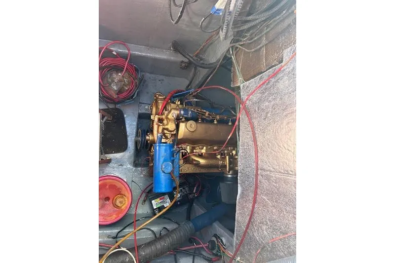 Slide: The Image of Engine compartment of a 1985 Custom model 60 with visible wiring and components. - 68