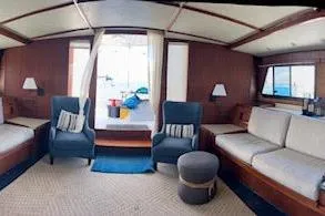 Slide: The Image of Interior of a 1985 Custom 60 yacht with cozy seating and nautical decor. - 7