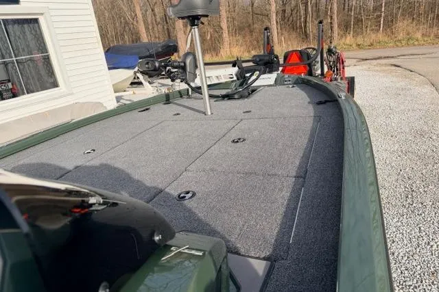 Slide: The Image of 2026 Vexus AVX1980 boat deck, featuring a spacious, carpeted surface in a wooded setting. - 7