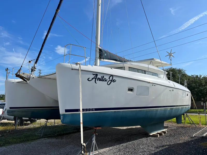 The Image of 2008 Lagoon 420 catamaran named Anita Jo on dry dock under clear blue sky. - 0