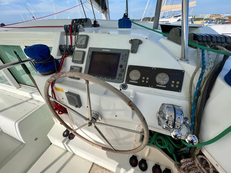 Slide: The Image of Lagoon 420 2008 yacht helm station with navigation instruments and steering wheel. - 17