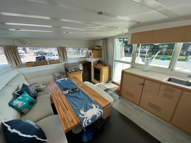 Slide: The Image of Interior of 2008 Lagoon 420 catamaran with modern kitchen and cozy seating area. - 2
