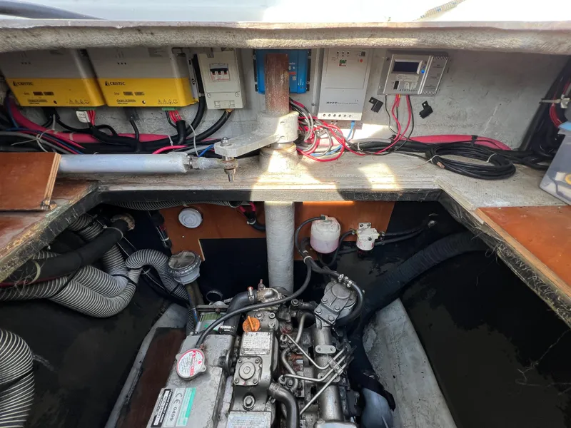 Slide: The Image of Engine compartment of a 2008 Lagoon 420 catamaran with visible wiring and components. - 21