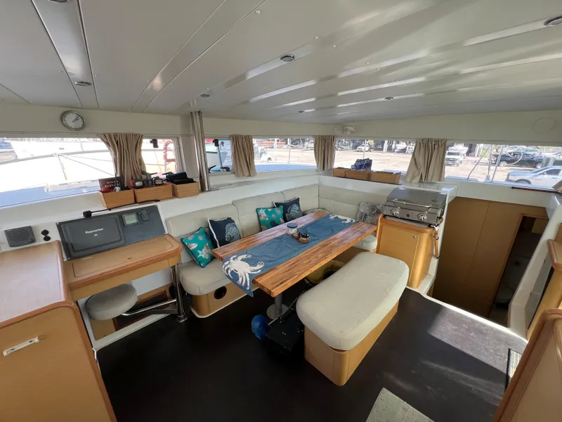 Slide: The Image of Interior of 2008 Lagoon 420 catamaran with spacious seating and dining area. - 24