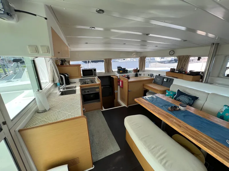 Slide: The Image of Interior of 2008 Lagoon 420 catamaran with kitchen and dining area. - 25