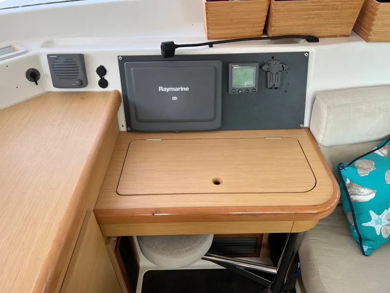 Slide: The Image of Lagoon 420 2008 yacht interior with Raymarine navigation system and wooden cabinetry. - 29