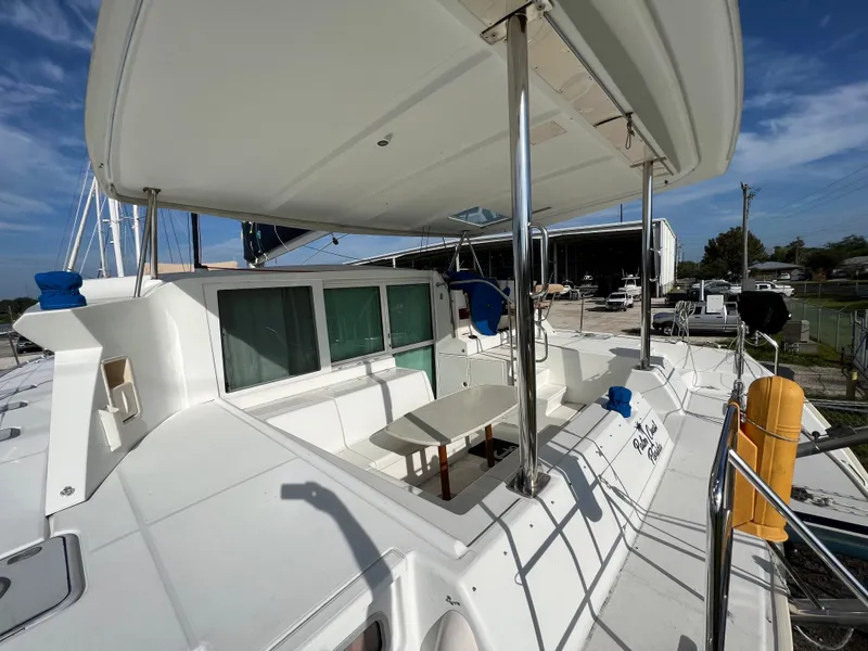 Slide: The Image of 2008 Lagoon 420 catamaran with spacious deck and covered seating area. - 3