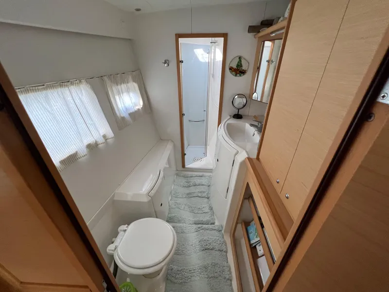 Slide: The Image of Lagoon 420 2008 yacht bathroom with modern fixtures and natural light. - 33