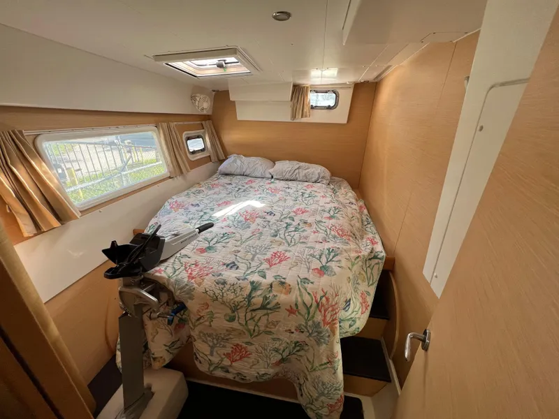 Slide: The Image of Interior cabin of 2008 Lagoon 420 catamaran with cozy bed and floral bedding. - 38