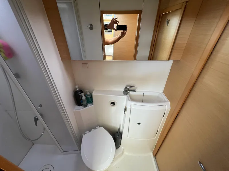 Slide: The Image of Compact bathroom in a 2008 Lagoon 420 catamaran with shower, toilet, and sink. - 41