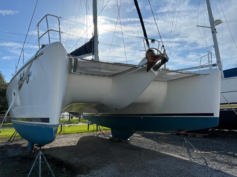 Slide: The Image of 2008 Lagoon 420 catamaran on dry dock under clear sky. - 5