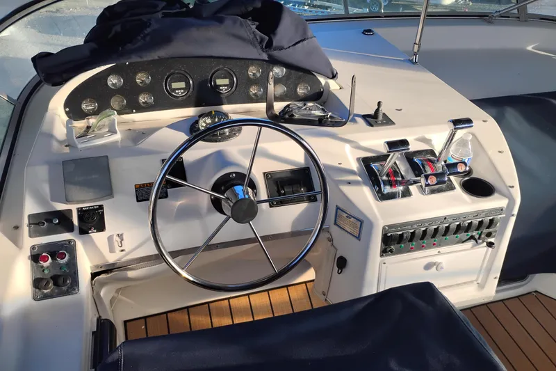 Slide: The Image of Cockpit of 2000 Bayliner 3988 Command Bridge Motoryacht with steering wheel and control panel. - 10