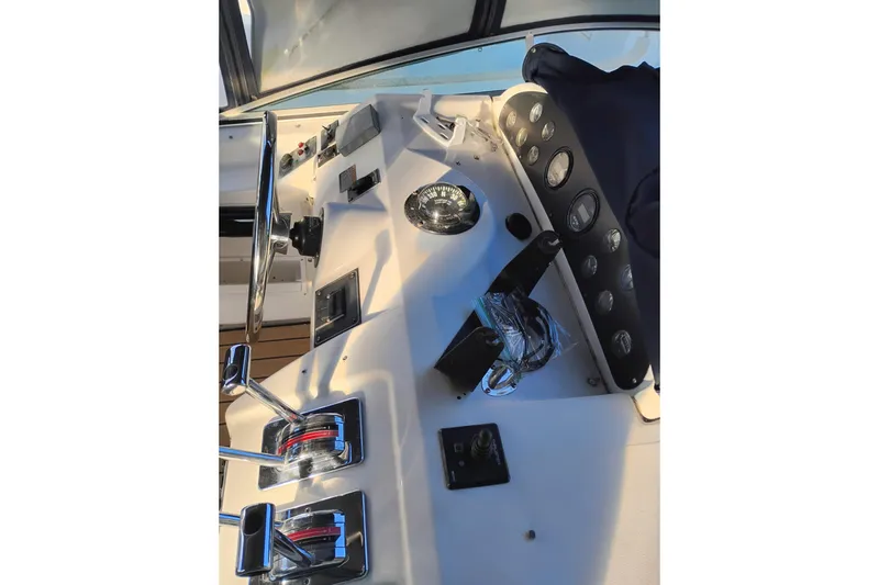 Slide: The Image of Control panel of 2000 Bayliner 3988 Command Bridge Motoryacht with steering wheel and gauges. - 12
