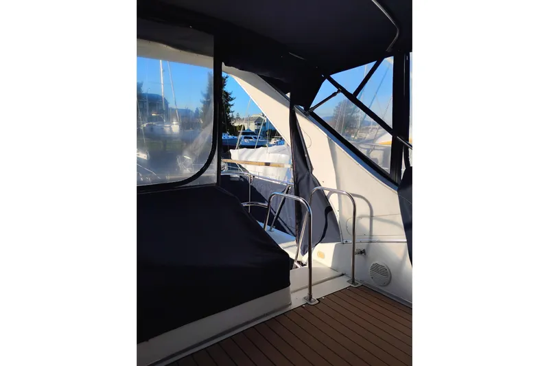 Slide: The Image of 2000 Bayliner 3988 Command Bridge Motoryacht interior with covered seating and railing. - 16