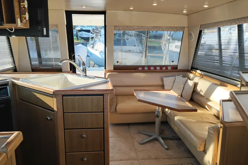 Slide: The Image of Interior of 2000 Bayliner 3988 Command Bridge Motoryacht with cozy seating and kitchen area. - 19