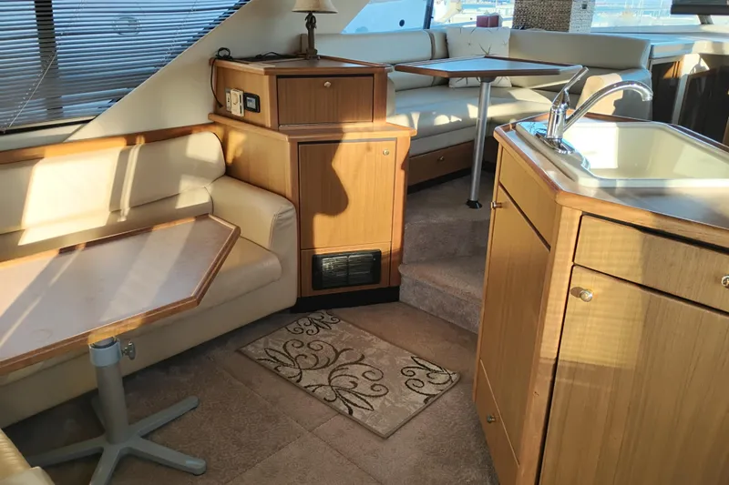 Slide: The Image of Interior of 2000 Bayliner 3988 Command Bridge Motoryacht with seating, table, and kitchenette. - 20