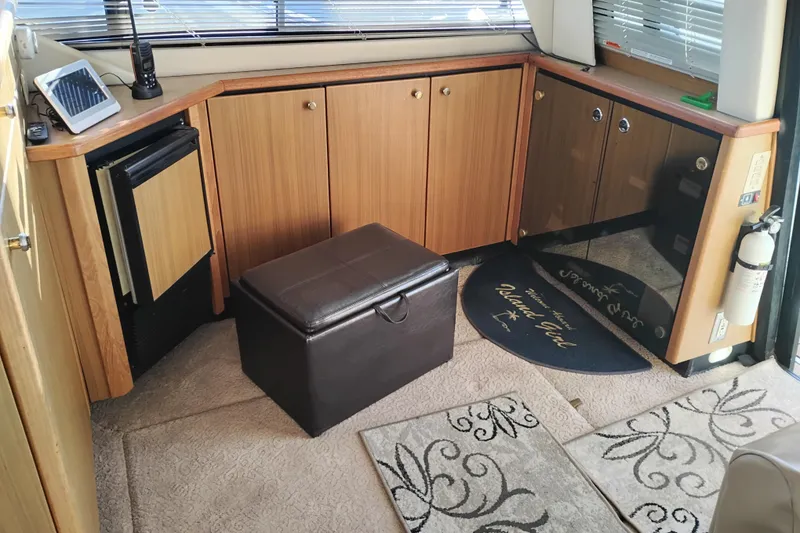 Slide: The Image of Interior of 2000 Bayliner 3988 Command Bridge Motoryacht with wood cabinets and leather ottoman. - 22