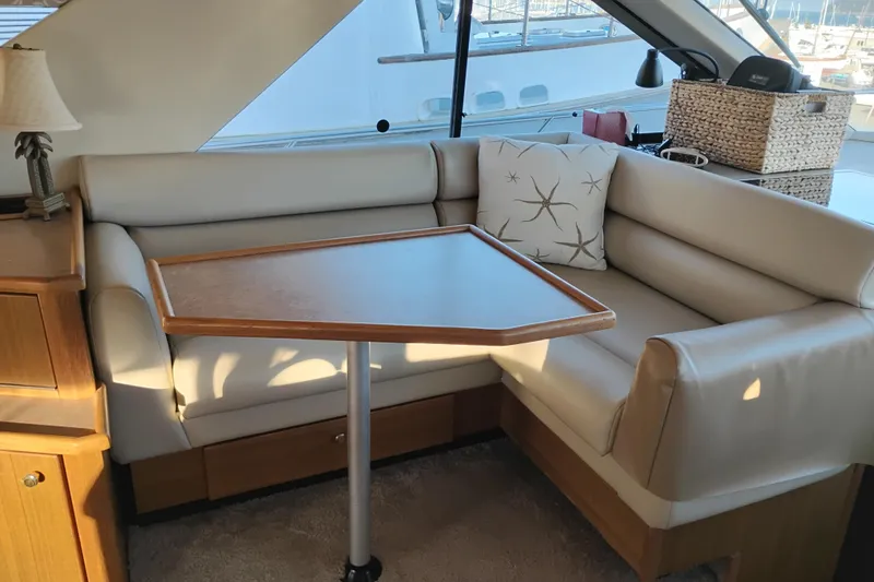 Slide: The Image of Interior of 2000 Bayliner 3988 Command Bridge Motoryacht with cozy seating and table. - 28