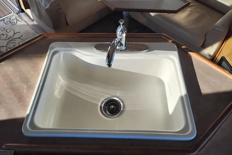 Slide: The Image of Sink in 2000 Bayliner 3988 Command Bridge Motoryacht interior, featuring modern faucet and countertop. - 31