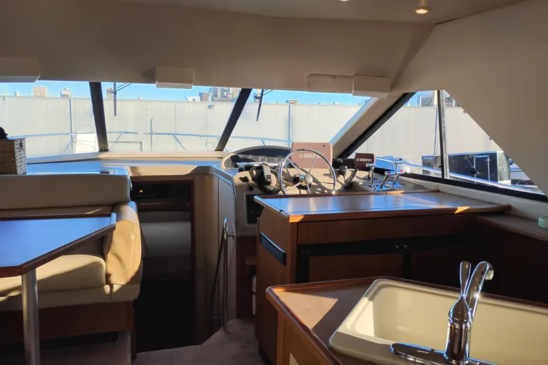 Slide: The Image of Interior of 2000 Bayliner 3988 Command Bridge Motoryacht with helm, seating, and sink. - 35