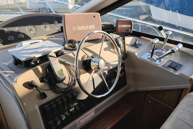 Slide: The Image of 2000 Bayliner 3988 Command Bridge Motoryacht helm with Garmin navigation equipment. - 36