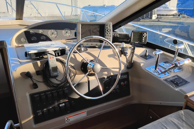 Slide: The Image of 2000 Bayliner 3988 Command Bridge Motoryacht helm with navigation instruments and controls. - 37