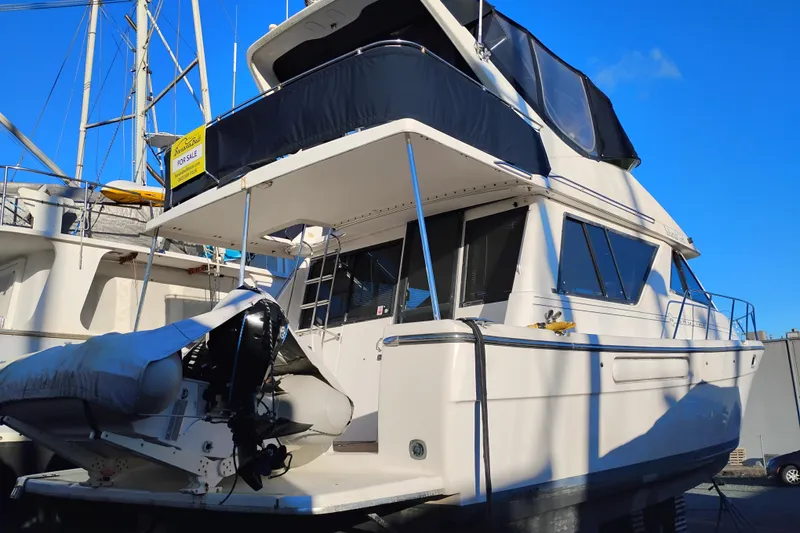 Slide: The Image of 2000 Bayliner 3988 Command Bridge Motoryacht for sale, docked with blue sky background. - 4