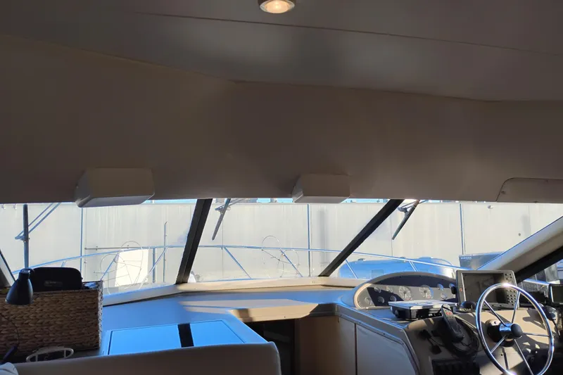 Slide: The Image of Interior view of 2000 Bayliner 3988 Command Bridge Motoryacht helm with steering wheel and navigation equipment. - 42