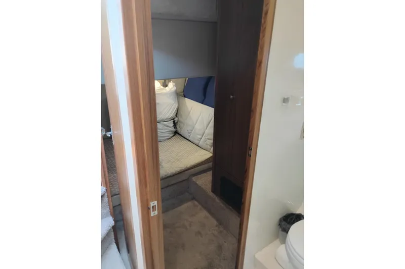 Slide: The Image of Interior cabin view of a 2000 Bayliner 3988 Command Bridge Motoryacht, featuring cozy bedding. - 44