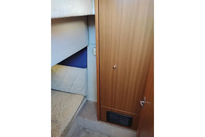 Slide: The Image of Interior cabin of 2000 Bayliner 3988 Command Bridge Motoryacht with wooden door and cozy bedding. - 45