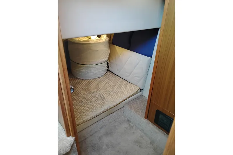 Slide: The Image of Cozy cabin interior of 2000 Bayliner 3988 Command Bridge Motoryacht with cushioned bedding. - 46