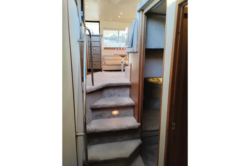 Slide: The Image of Interior of 2000 Bayliner 3988 Command Bridge Motoryacht with carpeted stairs and cozy cabin. - 49