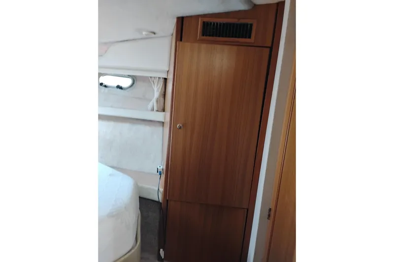 Slide: The Image of Interior cabin of 2000 Bayliner 3988 Command Bridge Motoryacht, featuring wood paneling and window. - 53