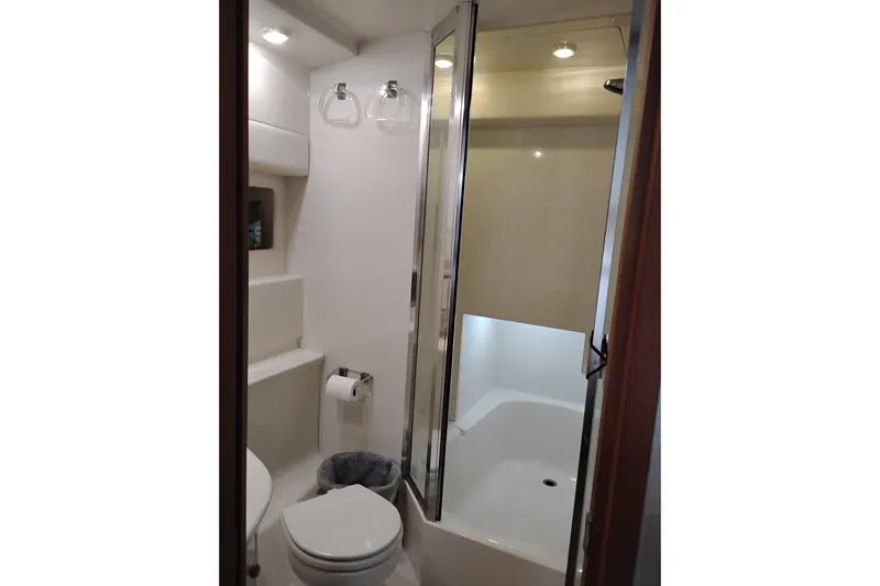 Slide: The Image of Bathroom interior of 2000 Bayliner 3988 Command Bridge Motoryacht, featuring shower and toilet. - 56