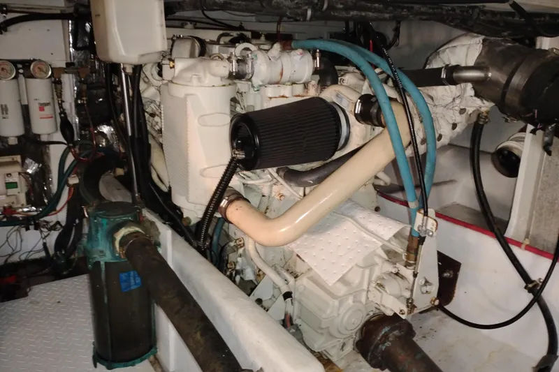 Slide: The Image of Engine room of 2000 Bayliner 3988 Command Bridge Motoryacht, showcasing mechanical components. - 58