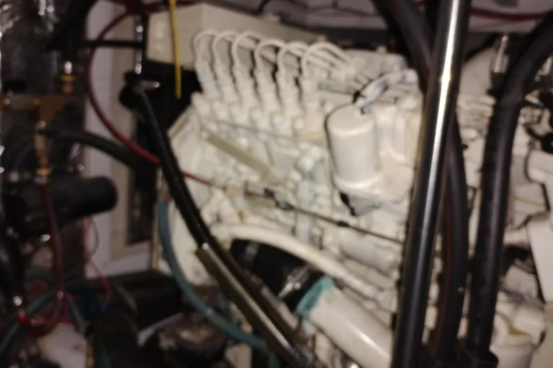 Slide: The Image of Engine room of 2000 Bayliner 3988 Command Bridge Motoryacht, showcasing complex machinery. - 59