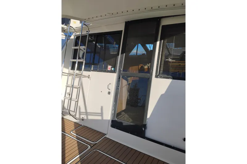 Slide: The Image of 2000 Bayliner 3988 Command Bridge Motoryacht with ladder and deck view. - 6