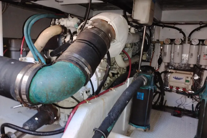 Slide: The Image of Engine room of 2000 Bayliner 3988 Command Bridge Motoryacht, showcasing complex machinery and components. - 60