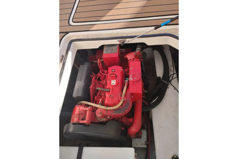 Slide: The Image of Engine compartment of 2000 Bayliner 3988 Command Bridge Motoryacht, featuring a red engine. - 64