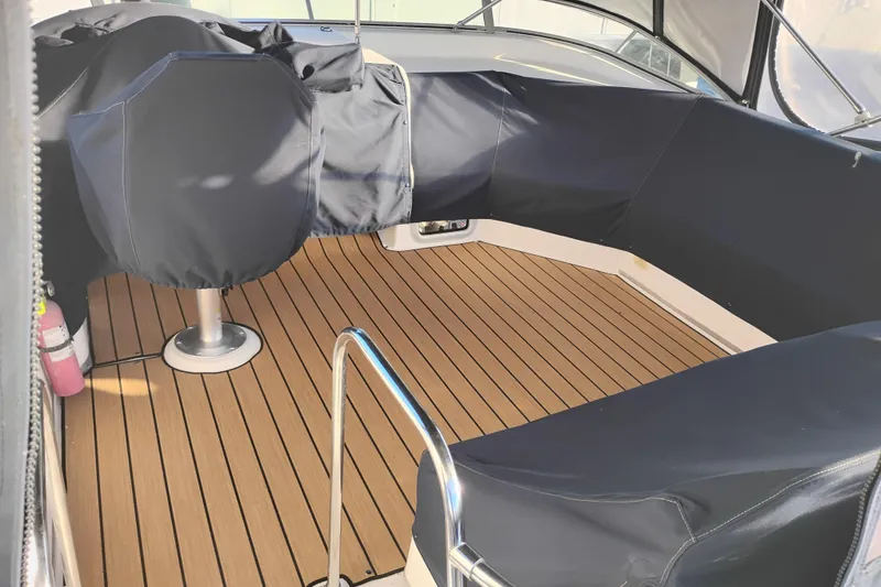Slide: The Image of 2000 Bayliner 3988 Command Bridge Motoryacht interior with covered seating and teak flooring. - 8