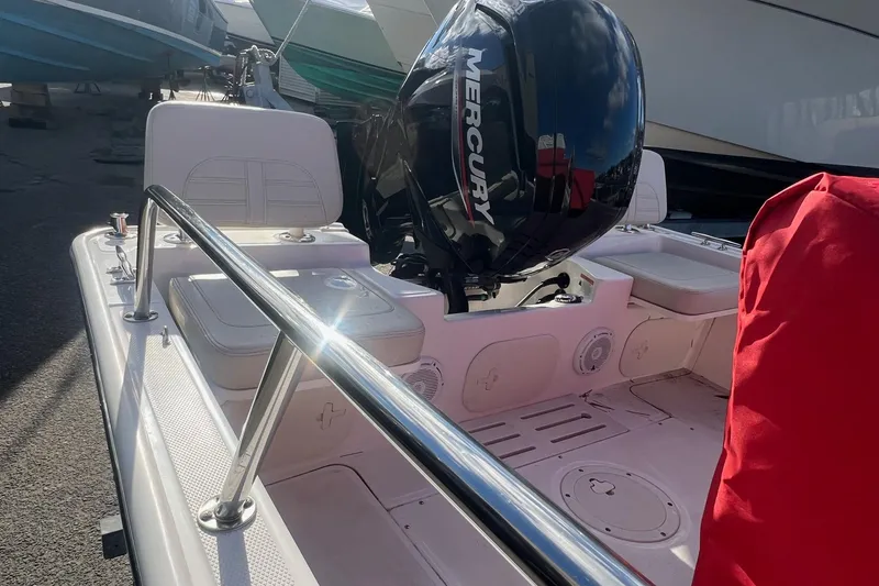 Slide: The Image of 2023 Boston Whaler 170 Montauk boat interior with Mercury engine, docked outdoors. - 4
