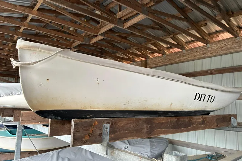 The Image of White 1990 FAIRFIELD row boat named "DITTO" stored in a wooden boathouse. - 0