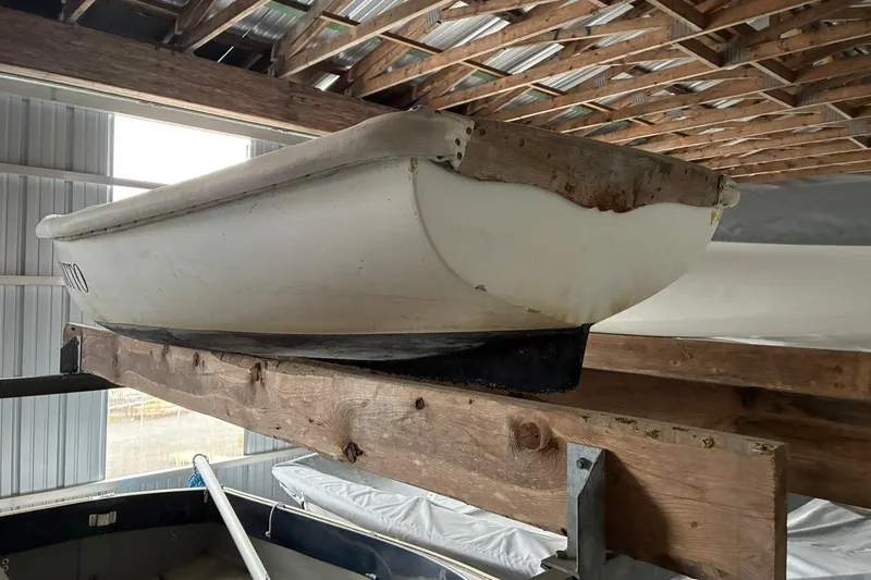 Slide: The Image of 1990 FAIRFIELD row boat stored on wooden beams in a shed. - 1