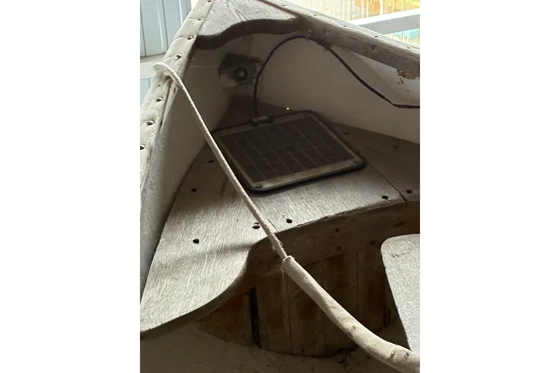 Slide: The Image of 1990 FAIRFIELD row boat interior with solar panel and wooden seating. - 2