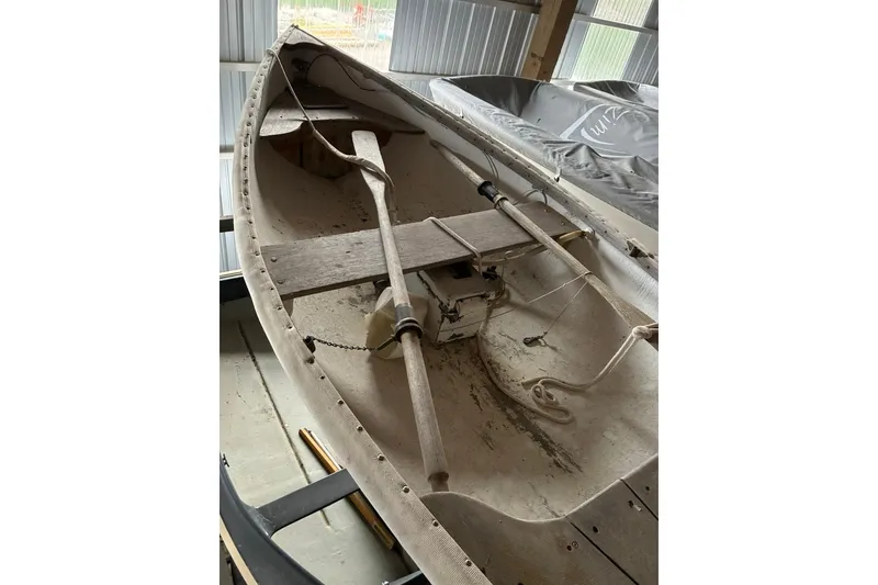 Slide: The Image of Vintage 1990 FAIRFIELD row boat with wooden oars in a storage shed. - 6